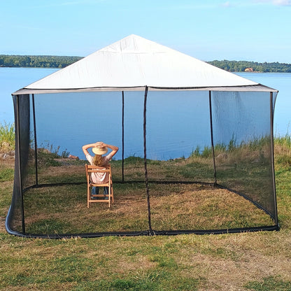 Woman showing the height of a black 250 × 1650 cm mosquito net installed on a 4 × 4 m square gazebo