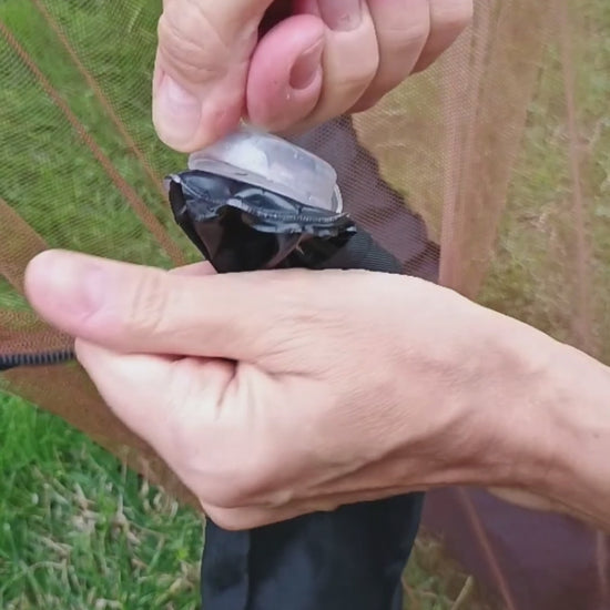 Video comparing a tight standard mosquito-net water-tube cap opened with pliers and the redesigned HousesNice cap opened by hand.